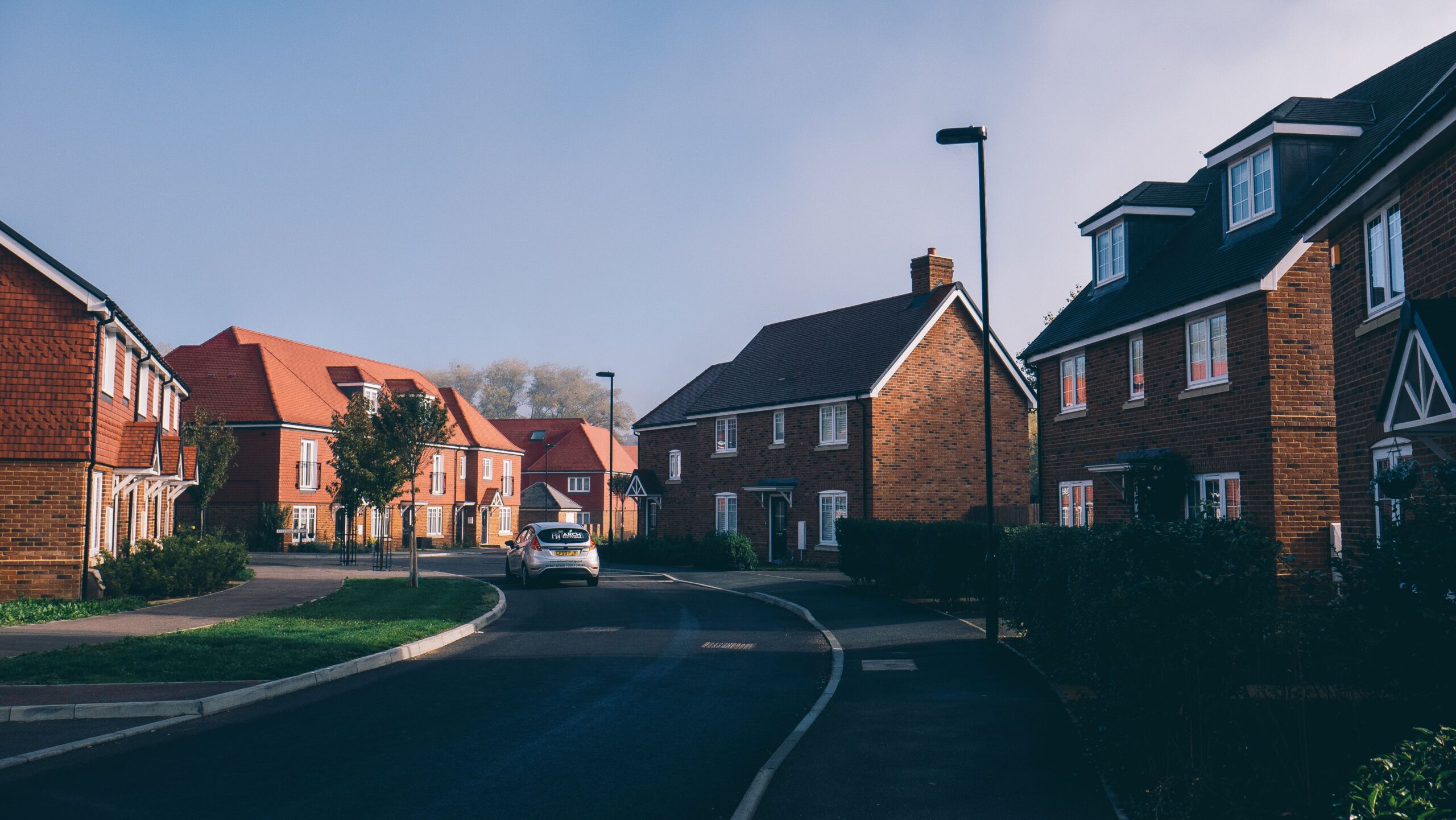 Serene morning view of an English suburban street lined with charming red-brick houses in Farnham.